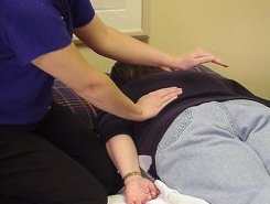 A therapist demonstrating postural drainage